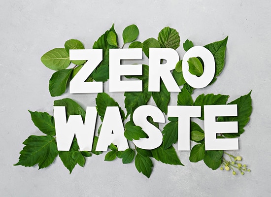 Zero waste-text på en bakgrund av löv